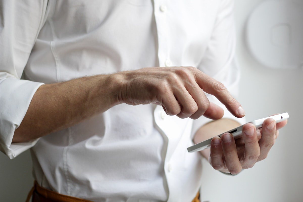 Personne utilisant un smartphone dans un contexte professionnel